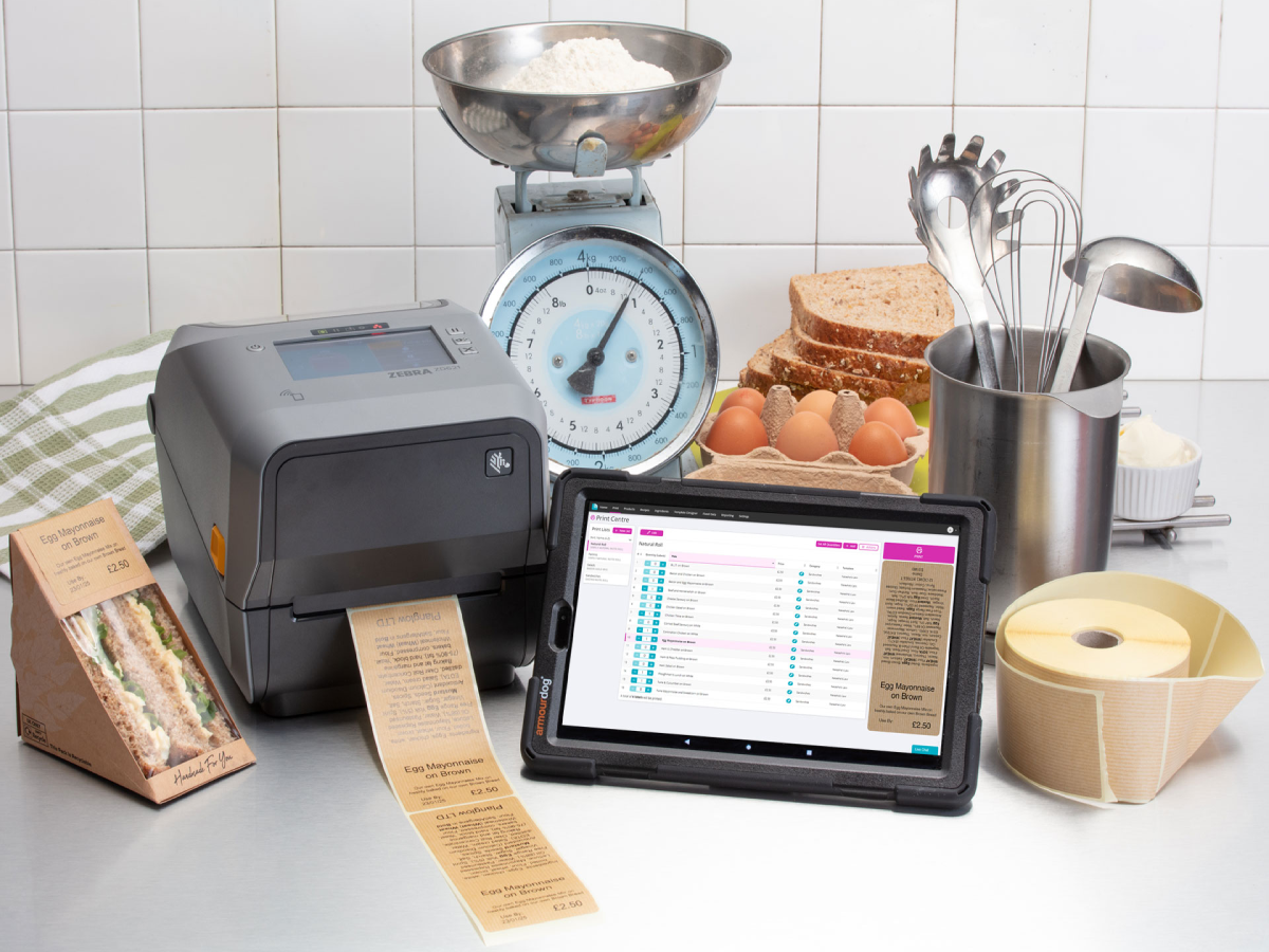 Chef mixing food in a bowl with label printer printing labels near by